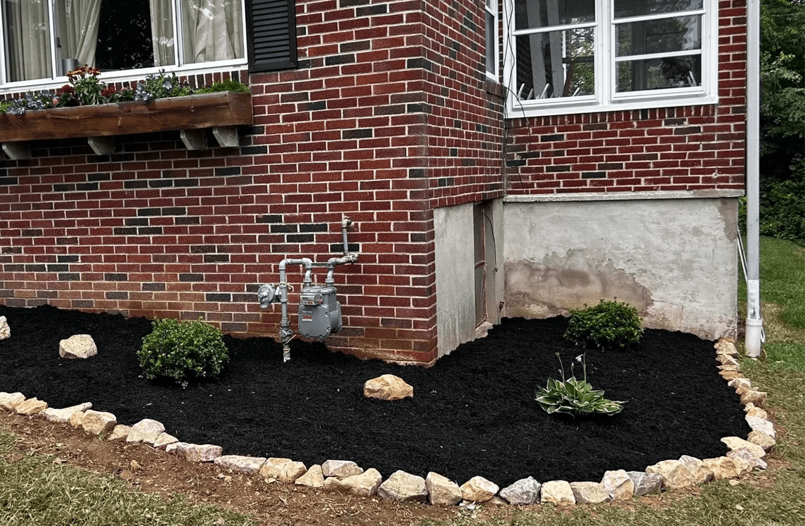 Brick house with landscaped garden bed