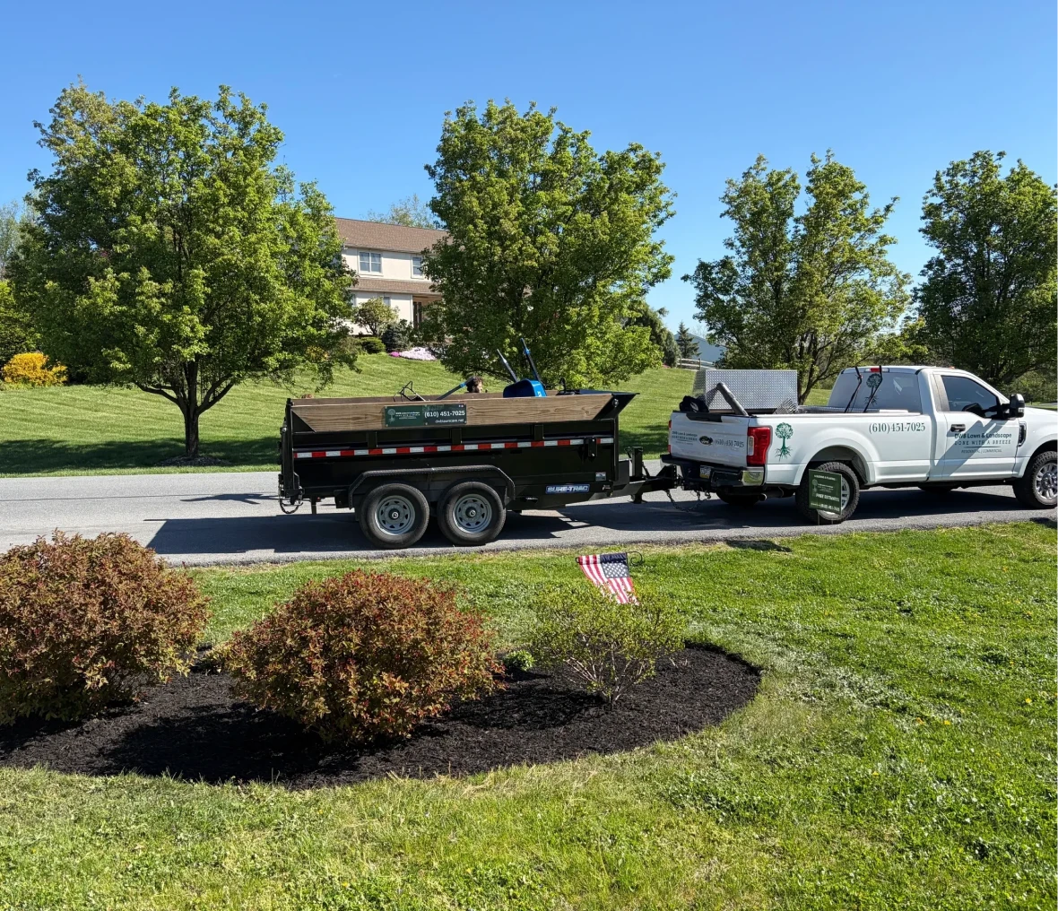 Landscaping truck and trailer on road