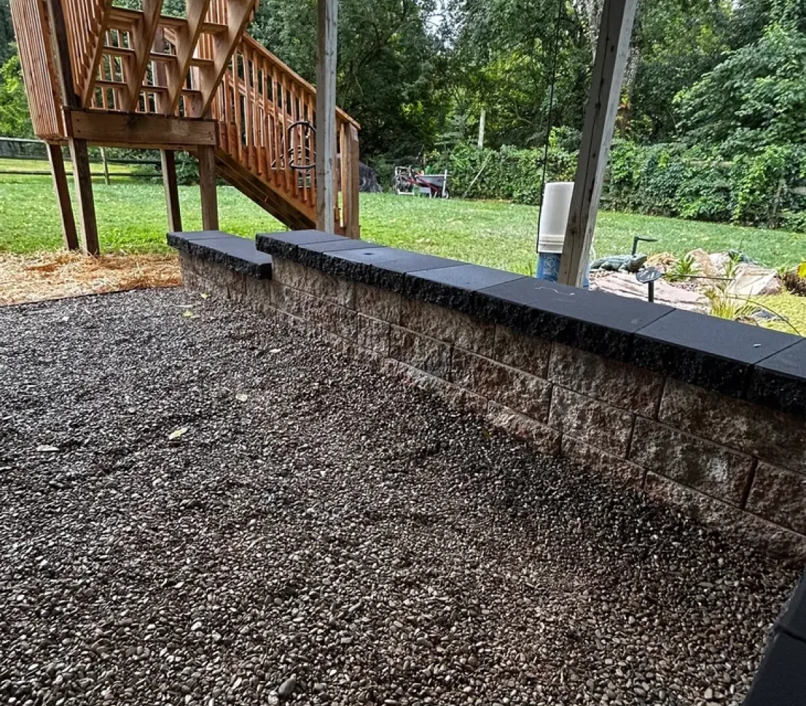 Backyard with gravel and wooden stairs